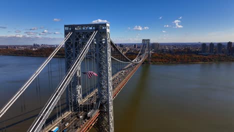 an aerial view of the george washington bridge from over fort lee, new jersey on a bright and sunny day in autumn