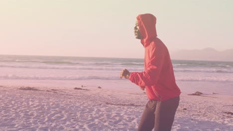 Animation-of-african-american-man-running-at-beach