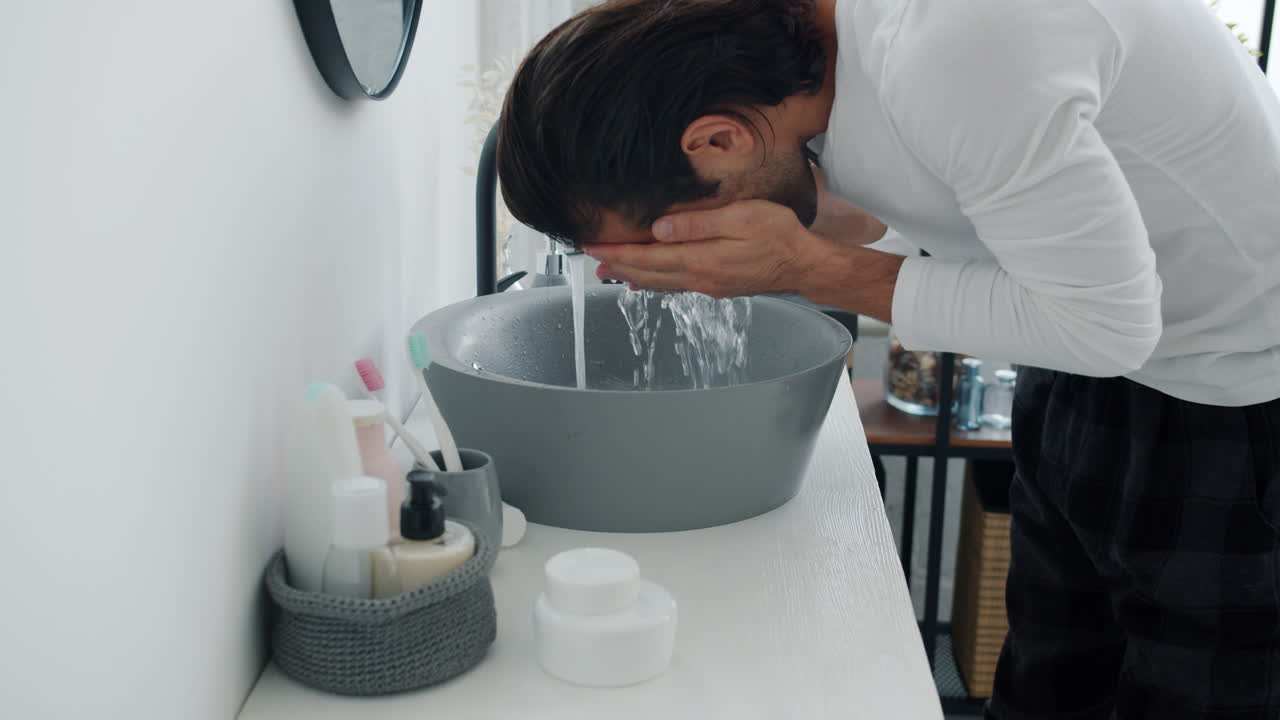 Man Washing Hands and Grooming in Bathroom