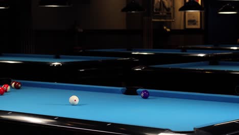 Playing-a-game-of-pool-billiards-and-hitting-the-yellow-ball-in-a-pocket