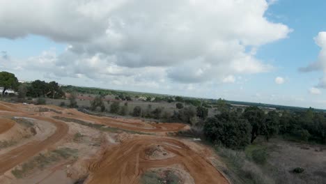 Aerial-view-of-empty-motocross-dirt-track-and-jumps-on-overcast-day
