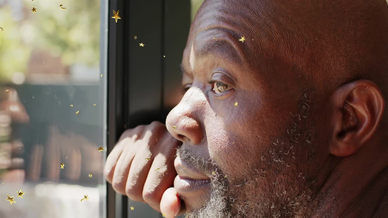 Senior man sitting by window holding chin, gold stars moving, causing eye shifts and wellness gaze