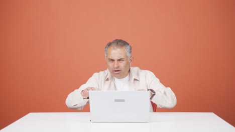 el hombre que mira la computadora portátil se frustra.