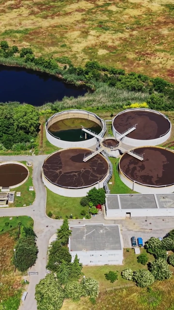 Water treatment facility located near a river surrounded by green land