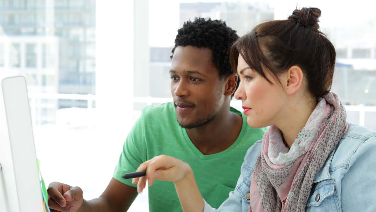 Handsome creative designer supporting his colleague 