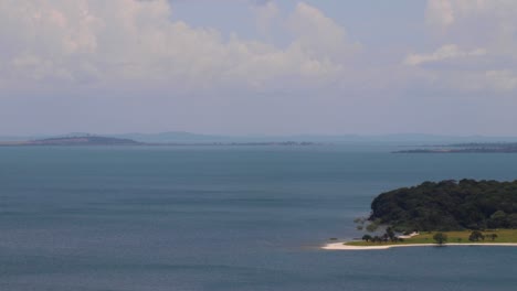 time lapse of archipelago (ssese islands) in kalangala, uganda. view from hill of water, peninsula, faraway islands, horizon and cloudy sky over lake victoria. gusts of wind on water