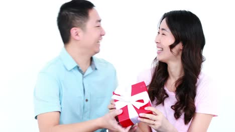 asian man giving a present to his girlfriend