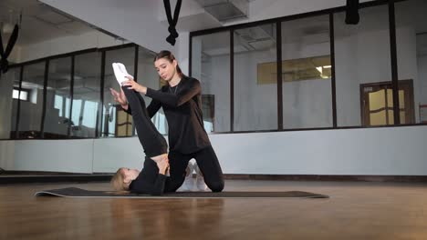 child and instructor in gym stretching