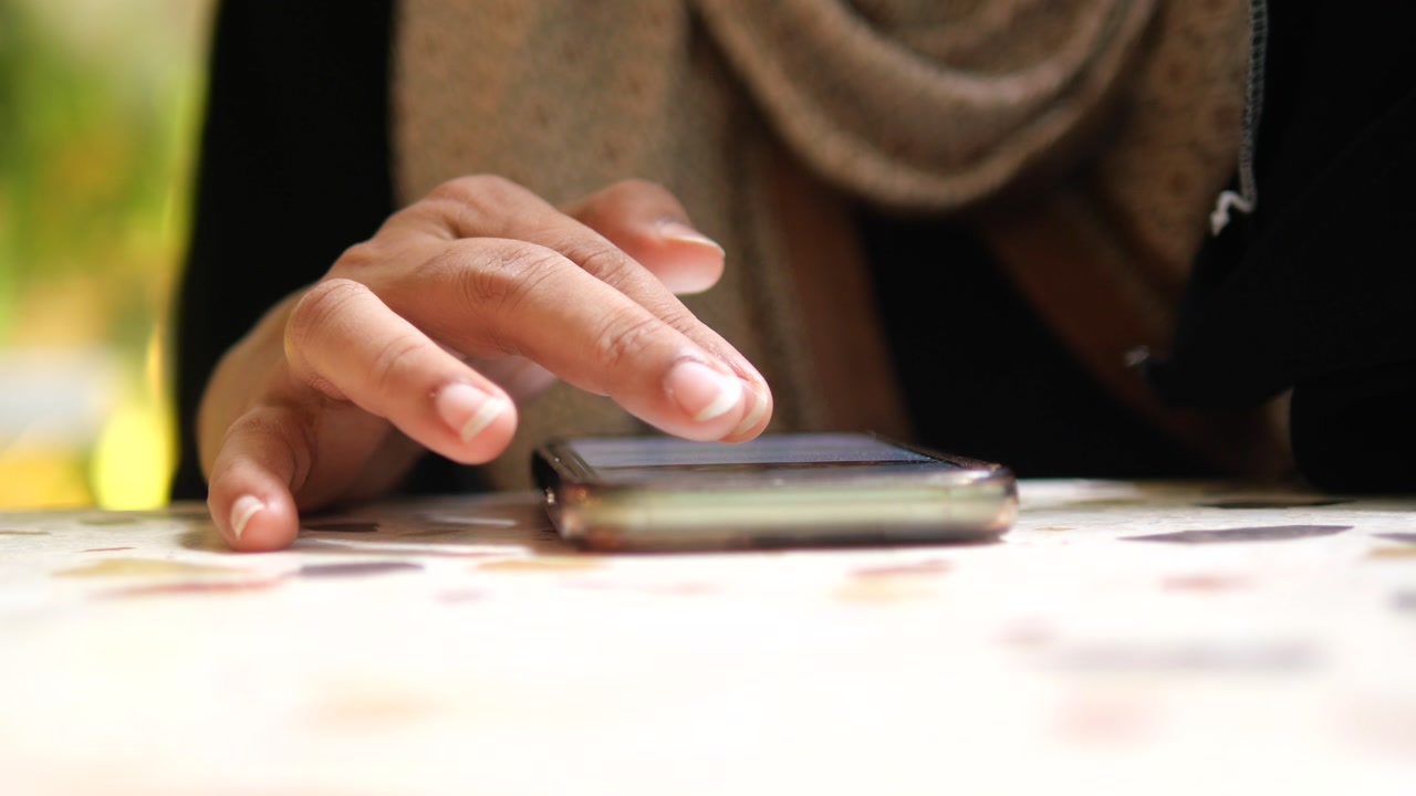 Close-up of a Hand Tapping and Scrolling on a Smartphone