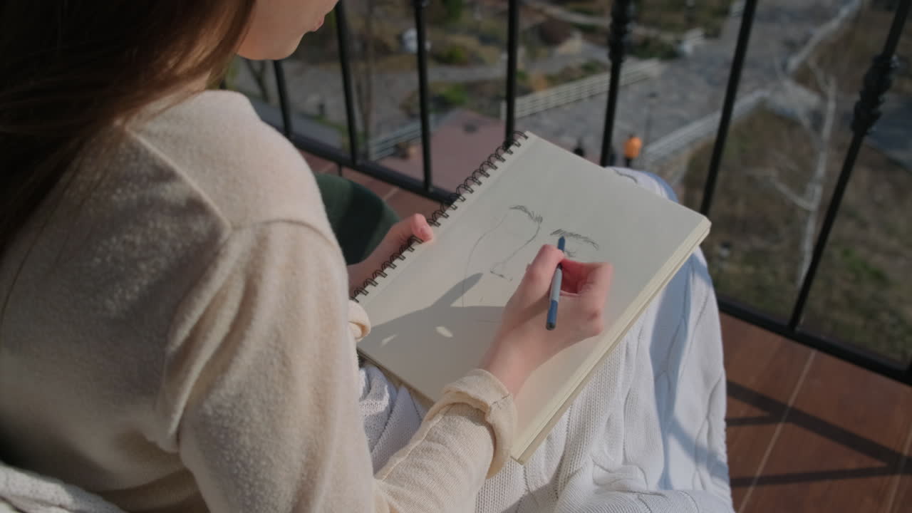 Woman Sketching on Balcony