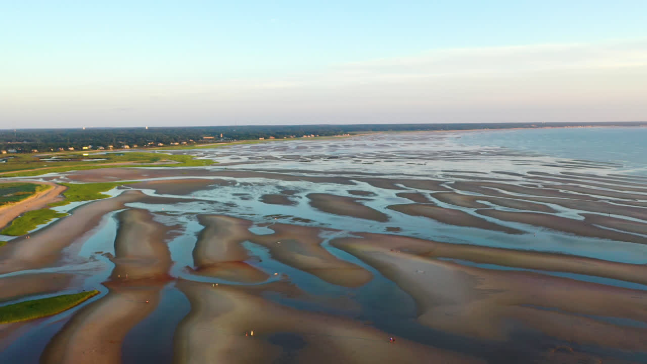 Cape Cod Bay Aerial Drone Footage of Beach at Low Tide with People Walking, Sand Bars and Puddles During Golden Hour, Pan Right