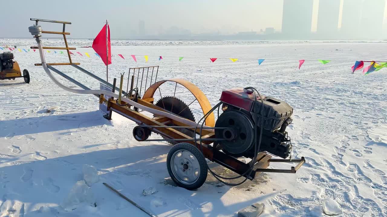 Handheld shot of an ice-cutting machine on the frozen Songhua River in Harbin, creating parallel cuts in the ice. China