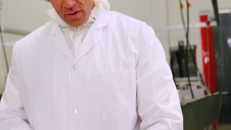 male butcher cutting raw meat