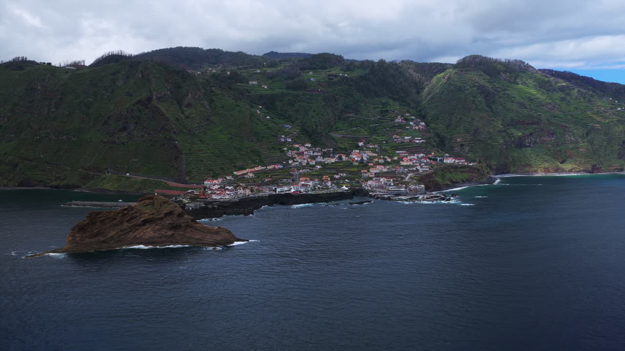 Aerial view of Porto Moniz, houses, volcanic islet and coastline in Madeira Island, Portugal