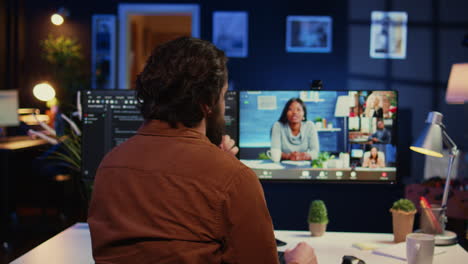 teleworking software engineer talking with colleagues during internet videocall