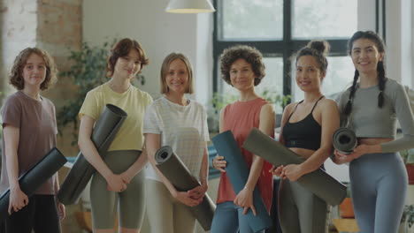 group portrait of cheerful women in yoga studio