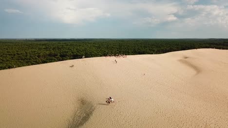 tourists on sand hills of dune of pilat in bordeaux, france