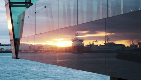 magic hour sunset reflections on harpa concert hall, reykjavik iceland