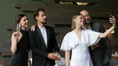 two couples posing for photo in restaurant