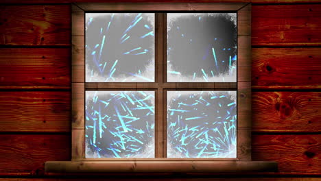 wooden window frame against blue fireworks exploding on black background