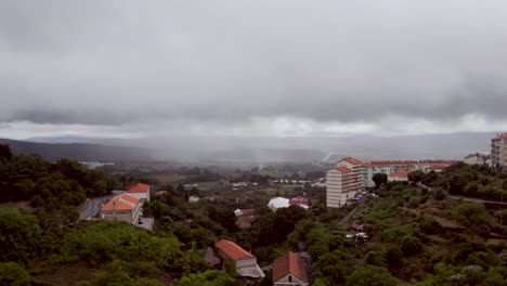 Drone-capture-of-housing-estate-living-in-a-lush-green-environment-with-a-cloudy-sky-in-the-background