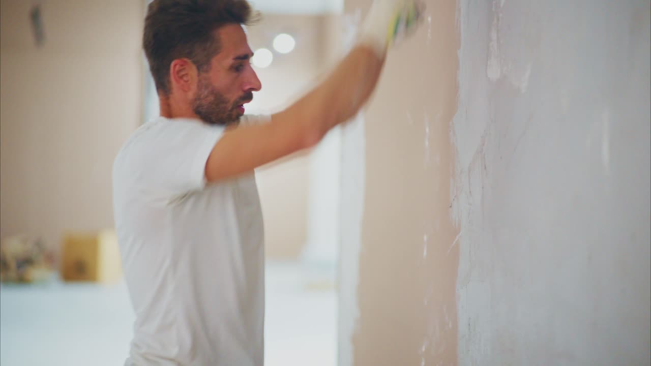 A Skilled Craftsman Undertaking Drywall Finishing in a Renovation Project, Showcasing Precision and Craftsmanship in the Creation of a Smooth Surface