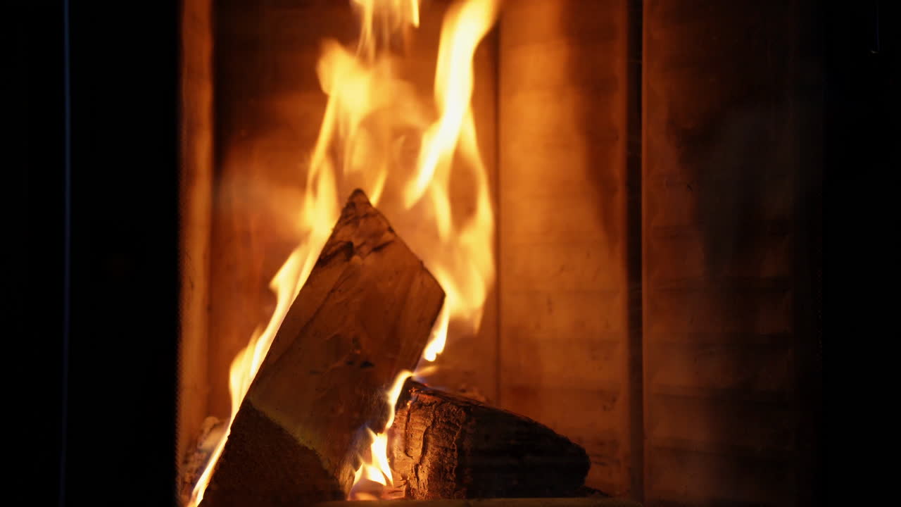 firewood burning in a fireplace on a cozy evening