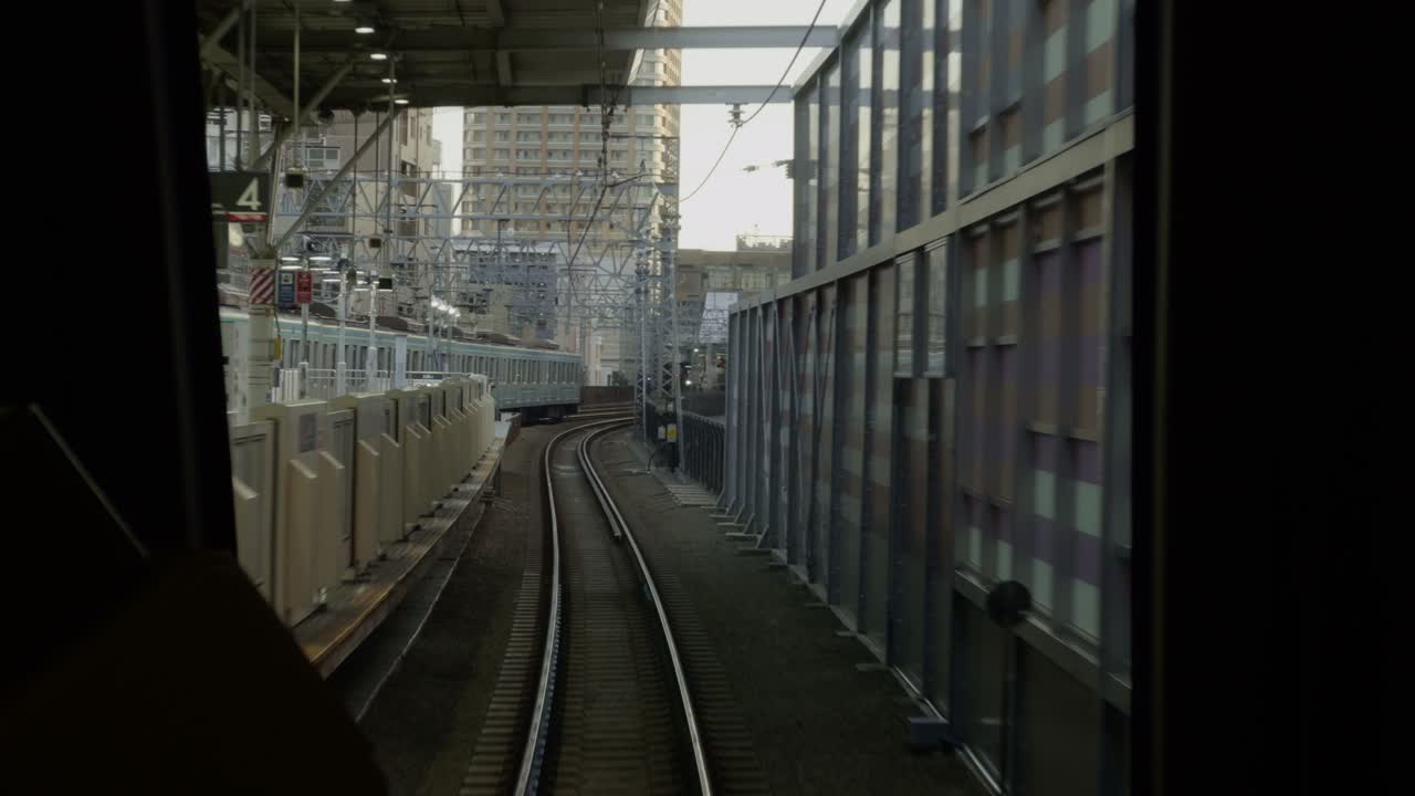 Tokyu Line Sunset Journey: City Views on Rails Experience a tranquil sunset from the Tokyu Line, with tracks and cityscape views as the train approaches Jiyugaoka