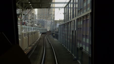 tokyu line sunset journey: city views on rails experience a tranquil sunset from the tokyu line, with tracks and cityscape views as the train approaches jiyugaoka