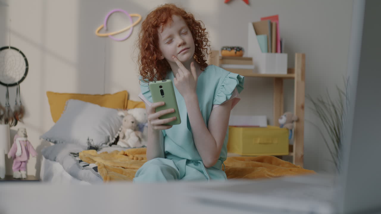 Girl using a smartphone in her bedroom