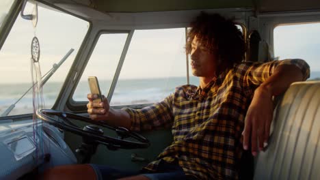 man using mobile phone in camper van 4k