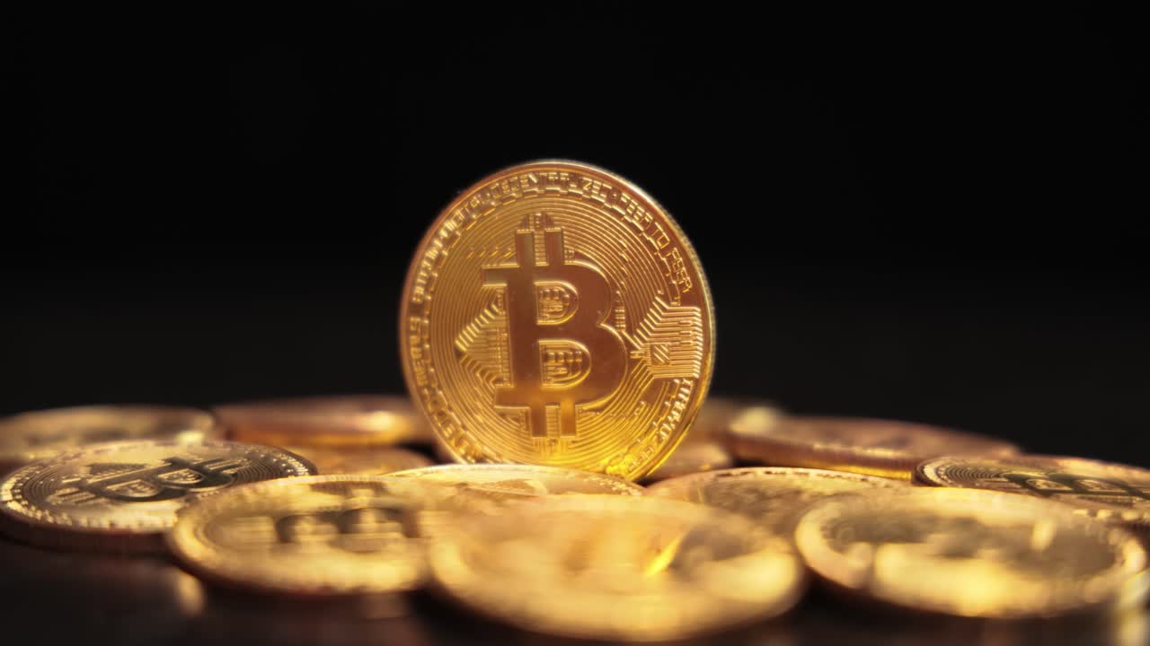 Gold Bit Coin BTC Cryptocurrency Coins on a black background. Bitcoin is a worldwide cryptocurrency and digital payment system called the first decentralized digital currency.