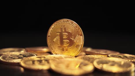 gold bit coin btc cryptocurrency coins on a black background. bitcoin is a worldwide cryptocurrency and digital payment system called the first decentralized digital currency.