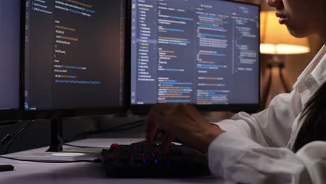 close up of asian female programmer creating innovative software engineer developing app, program, video game on desktop computer at home. terminal with coding language