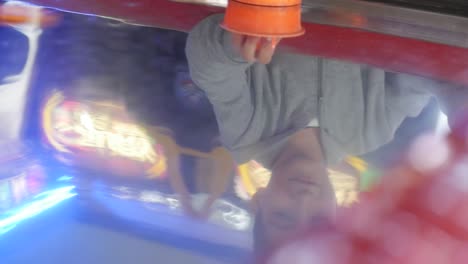 a young boy playing air hockey at the arcade