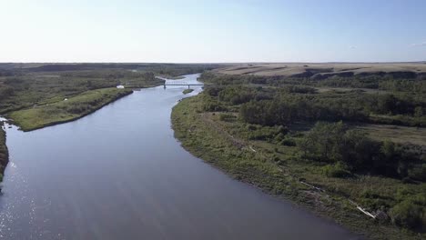 retreating aerial of bow river bridge on siksika nation in alberta