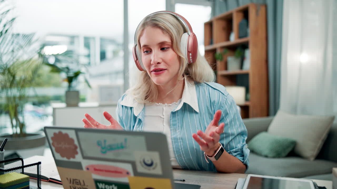 Woman on a video call using laptop and headphones