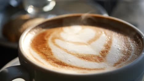 a close up of a cup of latte with latte art