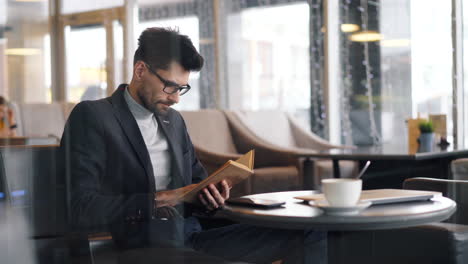 man reading in a cafe