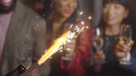 Close-Up-of-Sparklers-with-Friends-Celebrating-with-Champagne