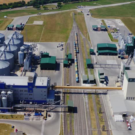 modern plant for agribusiness. aluminum containers for grains of industrial plant. innovative steel elevators on field. view from above.