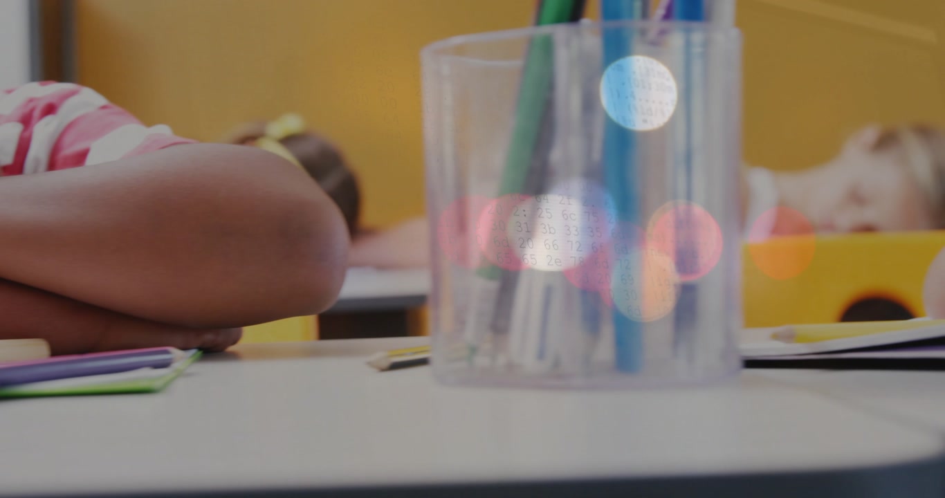 Slow camera panning while pencils sliding and pen cup appearing as boy resting for quiet class