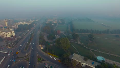 bombay, india, aerial flight over the highway in foggy weather, traffic is going on, telecom towers at the building, a horse riding ground and trraining areas