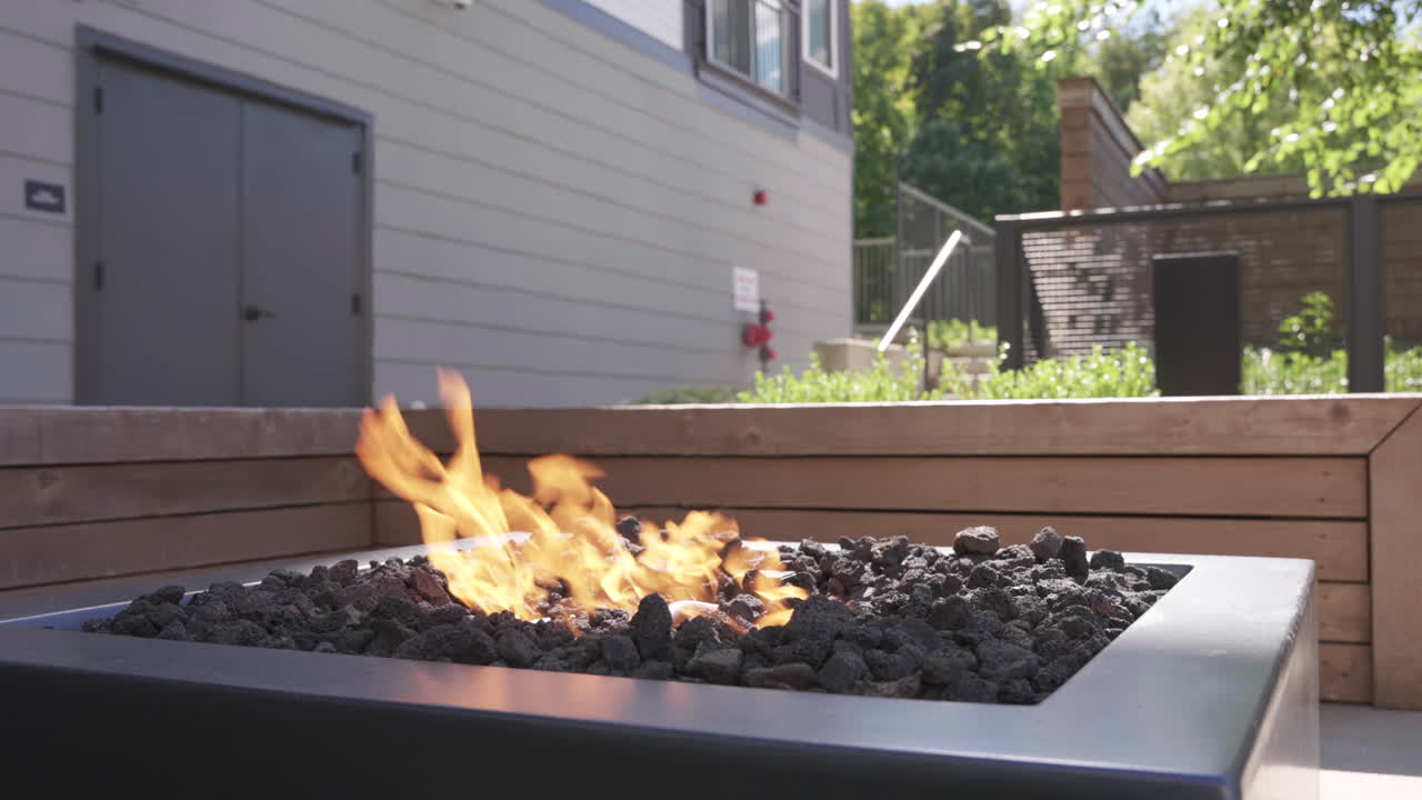 Modern Gas Fire Pit with Burning Flames on Outdoor Patio Deck
