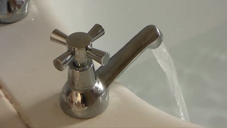 a tap runs hot water into a half full bath