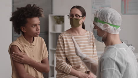 african boy high-fiving doctor