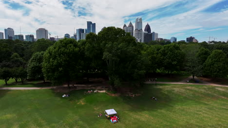 aerial ascending footage of park with green trees