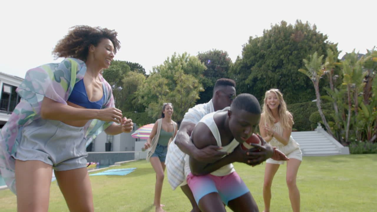 Diverse friends enjoy a playful game outdoors