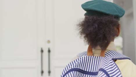 animation of happy african american girl in scout costume delivering packages