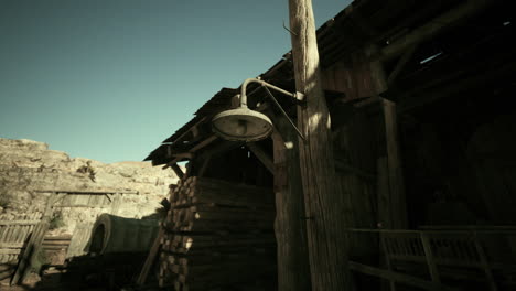 a rustic wooden barn with a vintage light and stacked timber at dusk